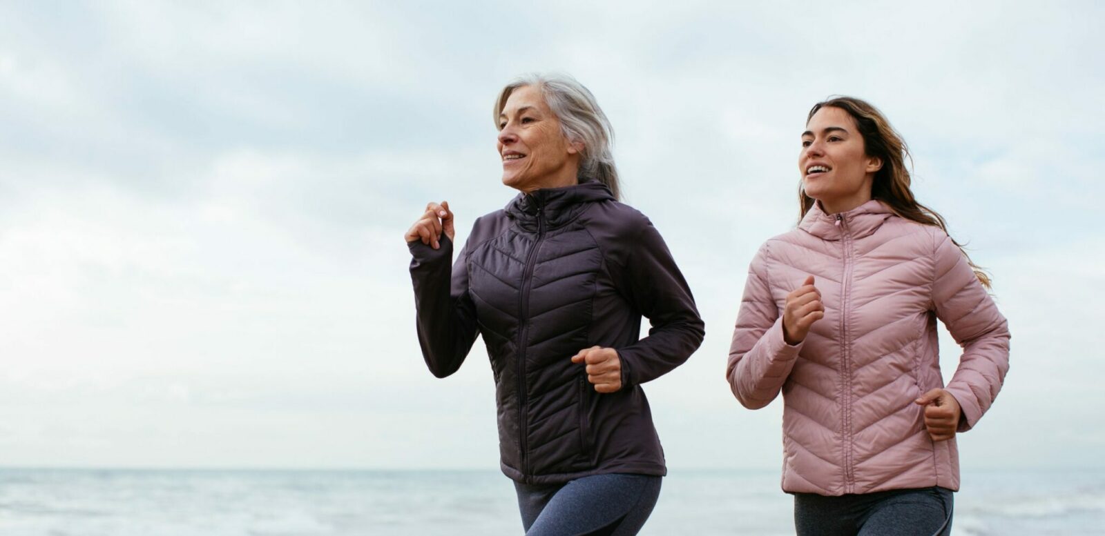 Two women jogging on the beach