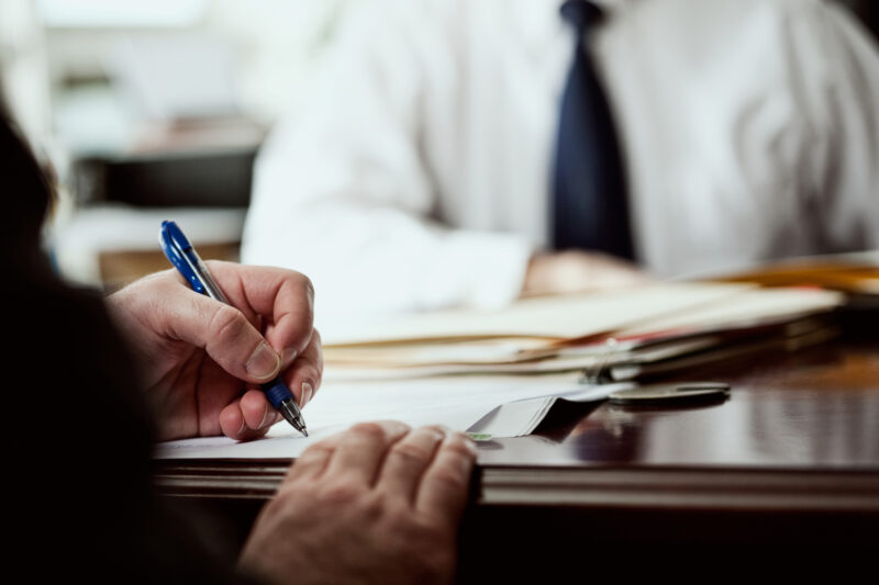 Woman Signing Document