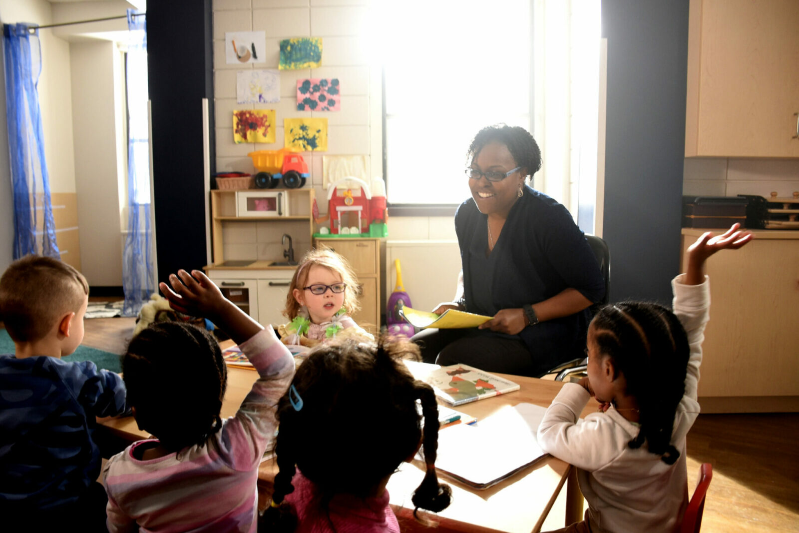 Woman teaching in front of three children