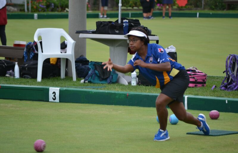 A bowler from BC delivering a lawn bowl