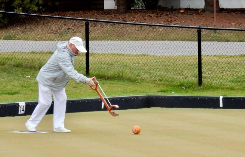 Delivering a lawn bowl using an assistive device