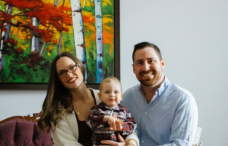 young blood recipient sits with his parents on either side