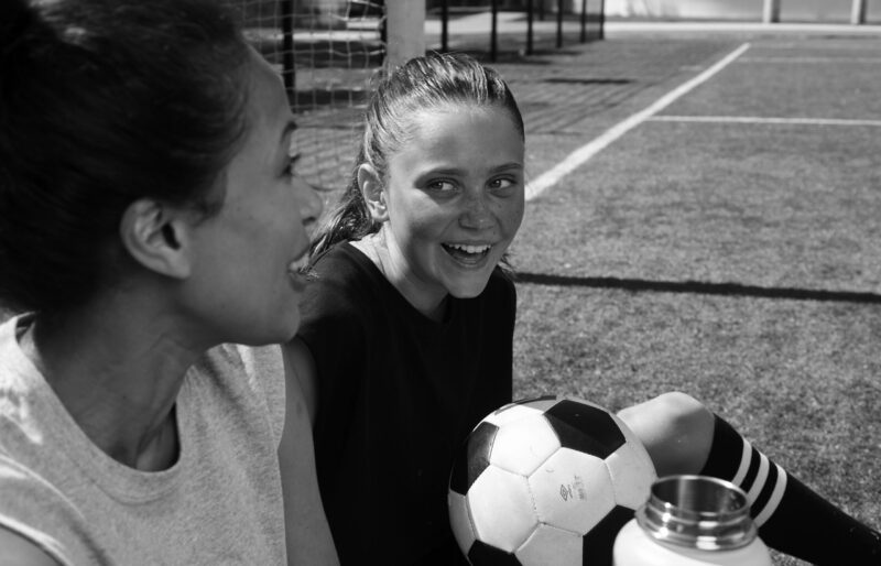 big-and-little-playing-soccer