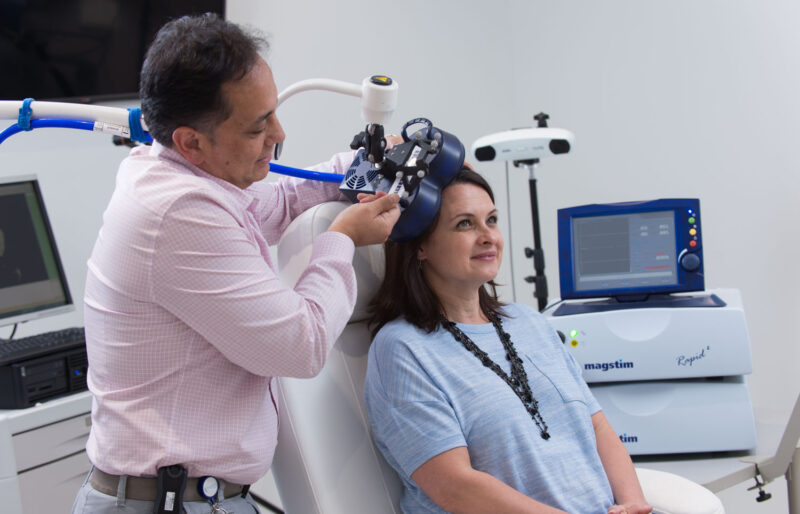 doctor performing procedure on patient with equipment