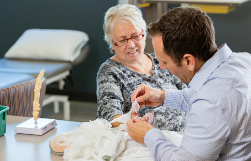 Therapist examines his patient's hands
