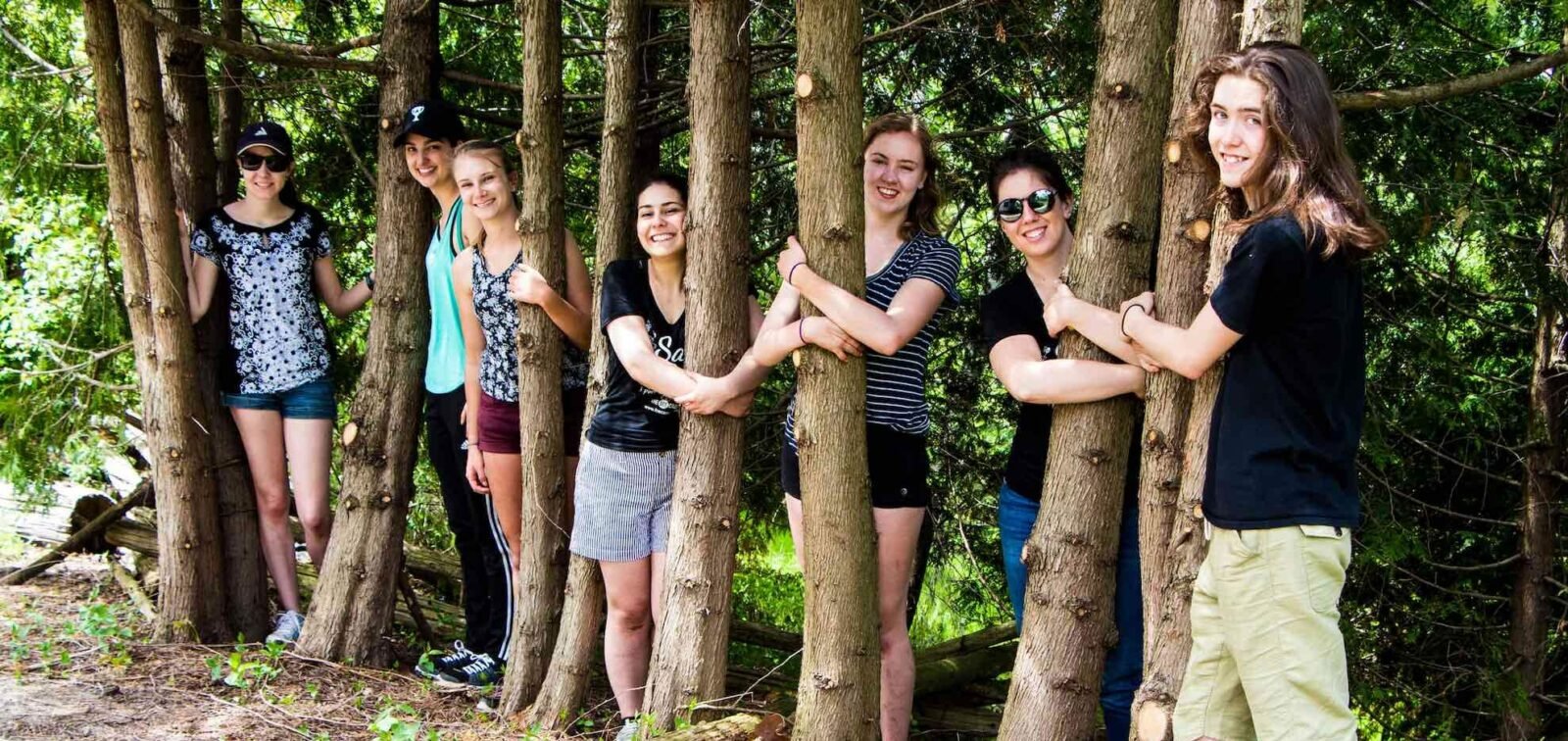 NAWL summer students and volunteers tree hugging