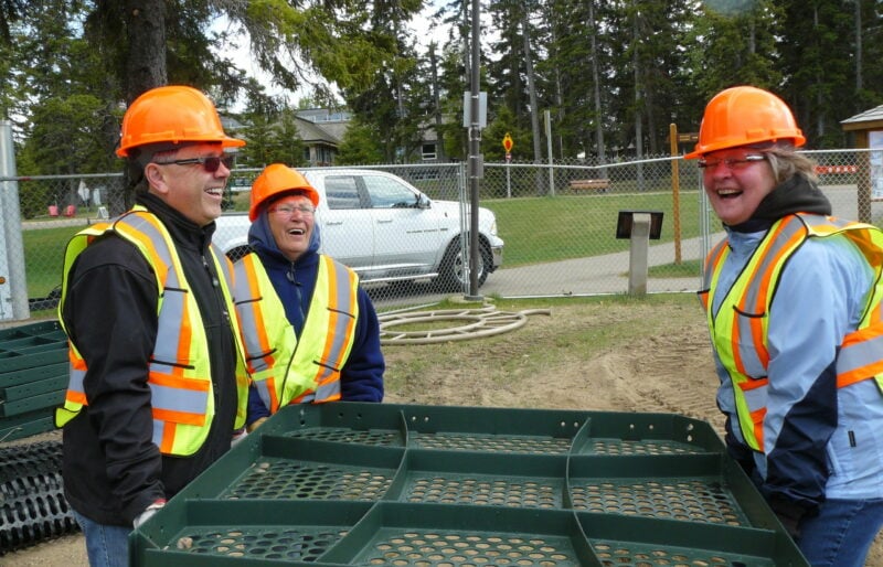 Volunteers work together during construction of the Bears on the Beach Playground at Waskesiu Lake