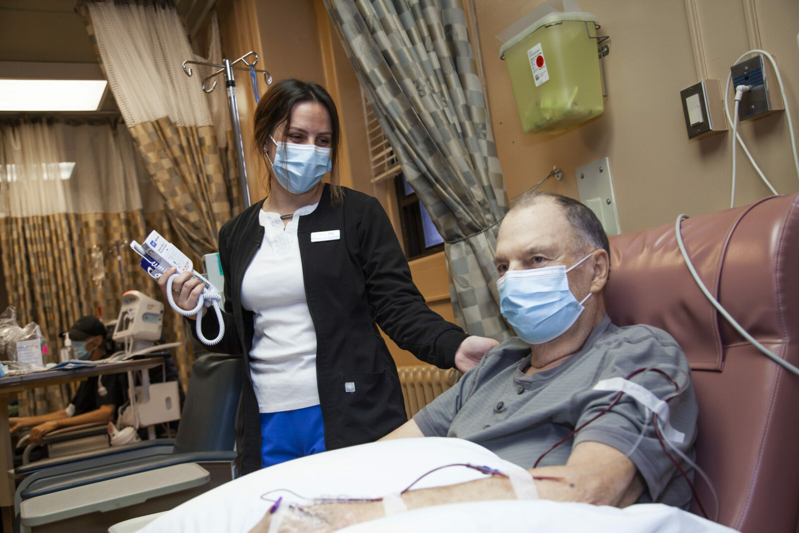 Nurse comforts patient undergoing chemotherapy at the QEII's Medical Day Unit