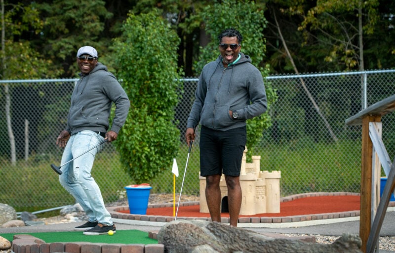 Two people celebrate a great putt at Little Al's Mini Golf at Waskesiu Lake