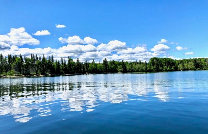 A beautiful photo of Waskesiu Lake reflected in the water