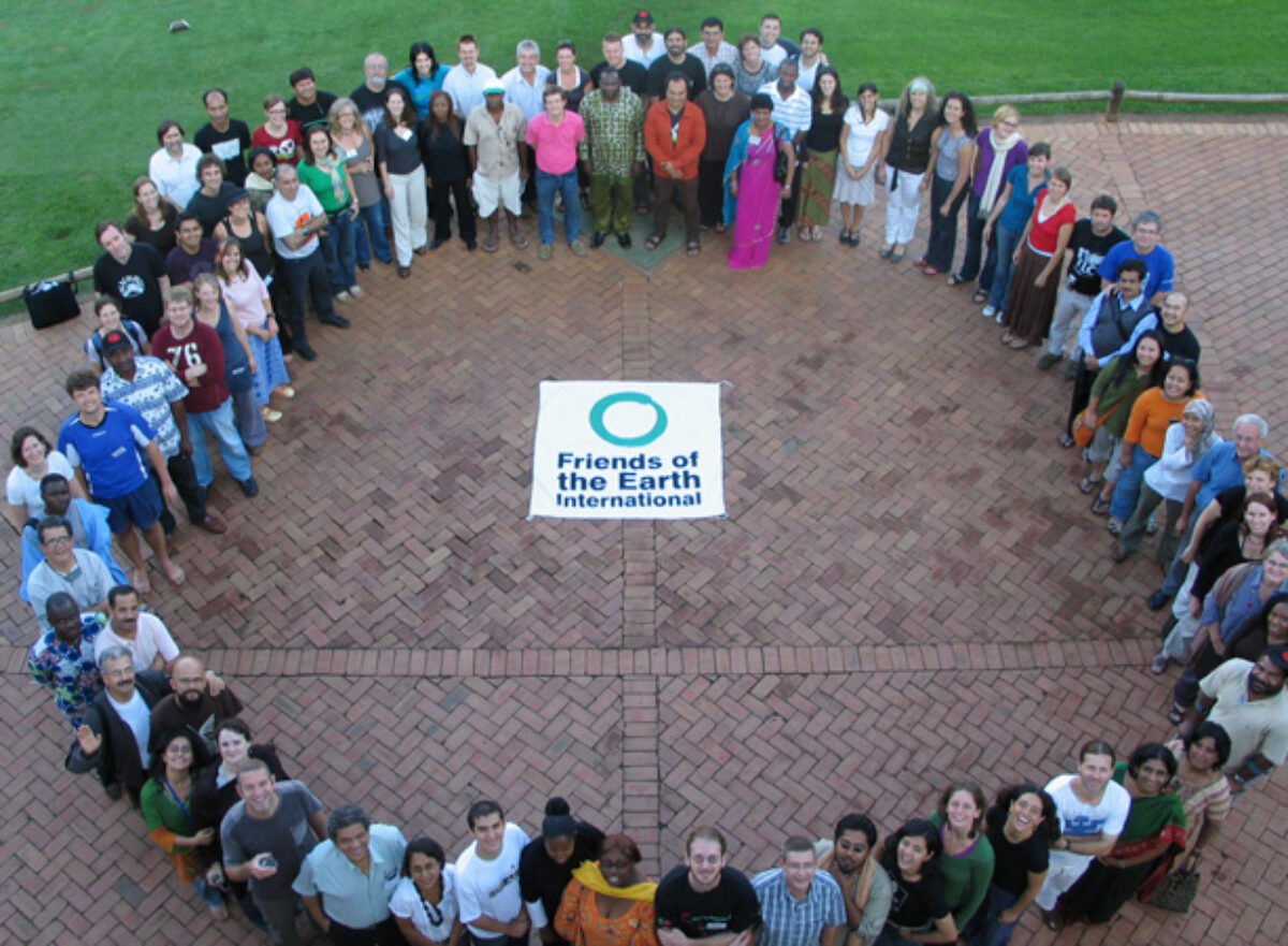 Group photo from Friends of the Earth International meeting, members from 75 country groups standing in a circle.
