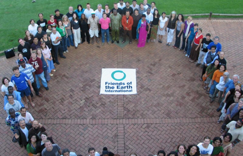 Group photo from Friends of the Earth International meeting, members from 75 country groups standing in a circle.