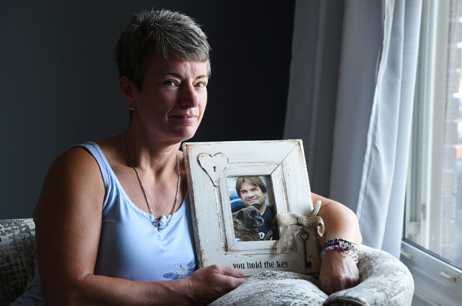 Women holding a picture of a lost loved one