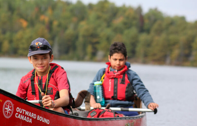 Image of two kids in a canoe