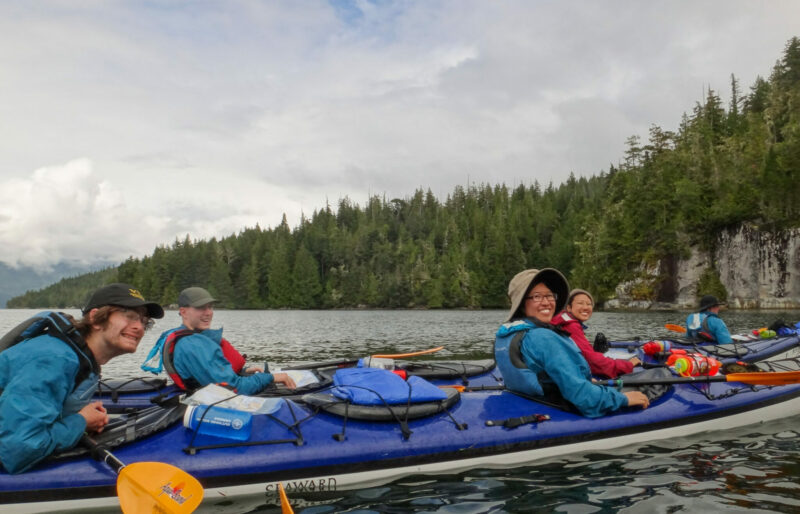Image of 4 kayakers on the water in tandem kayaks