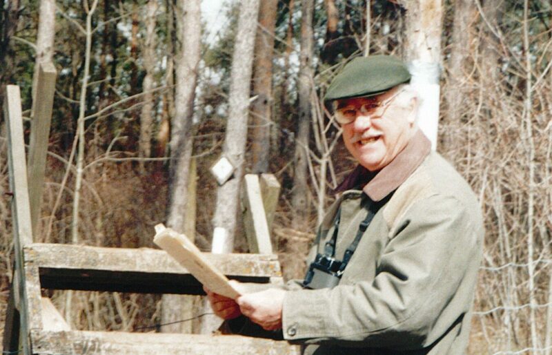 Dr. Philip R. Gosling, Honorary President & Co-Founder, standing at a stile on the Bruce Trail. Dr. Gosling has shared his decision to include a gift to the Bruce Trail Conservancy in his will.