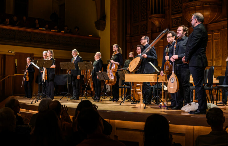 musicians standing facing the audience during applause