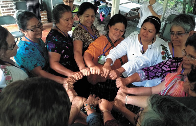 Women in circle, fists together