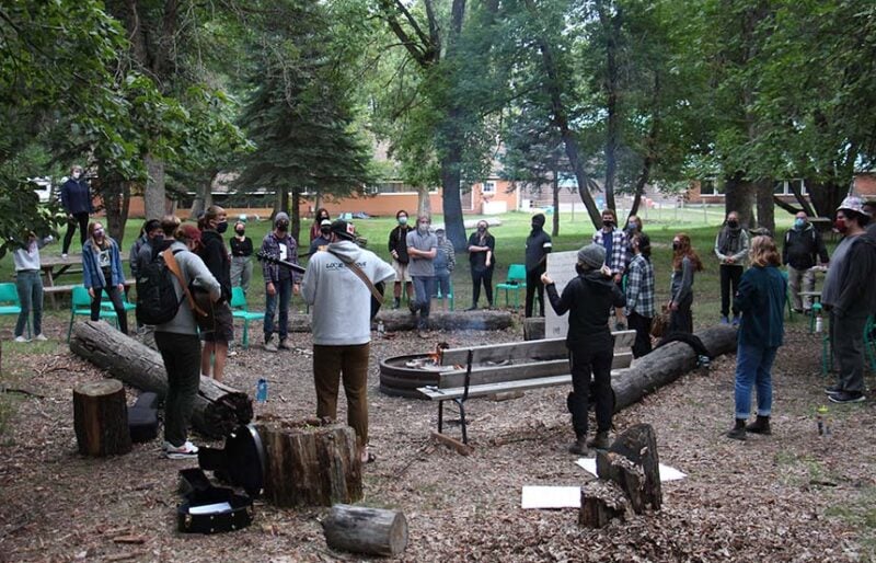 People around a campfire, singing