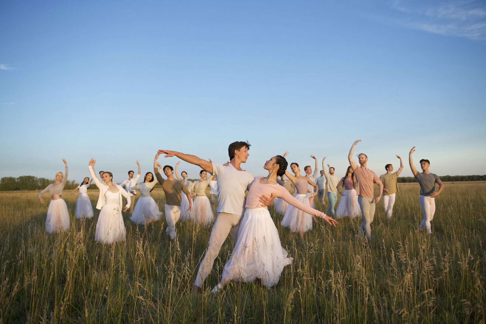 Dancers posing in a prairie field