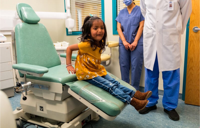 IWK patient Norah Matchett sitting in a chair at the IWK