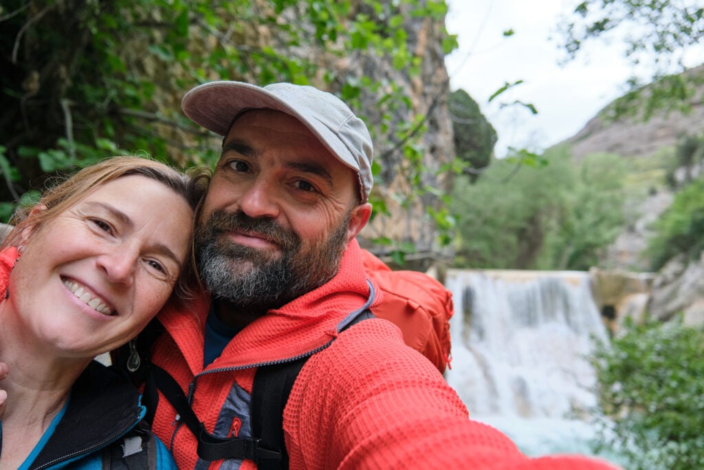 Benoit and Julie hiking together after using estate planning, life insurance and charitable giving to leave gifts to both family and charity.