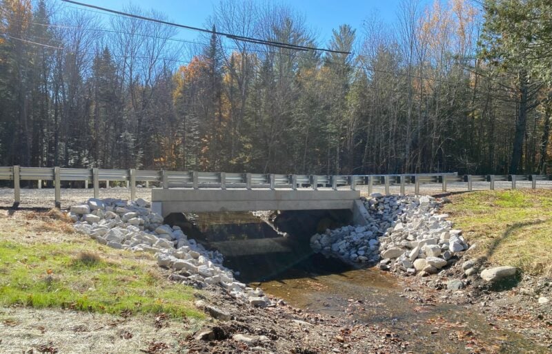 newly installed bridge with a free flowing stream below