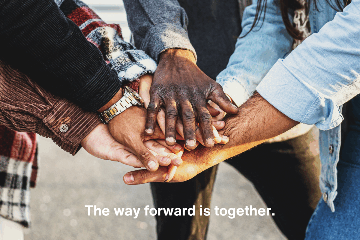 group of people clasping hands together