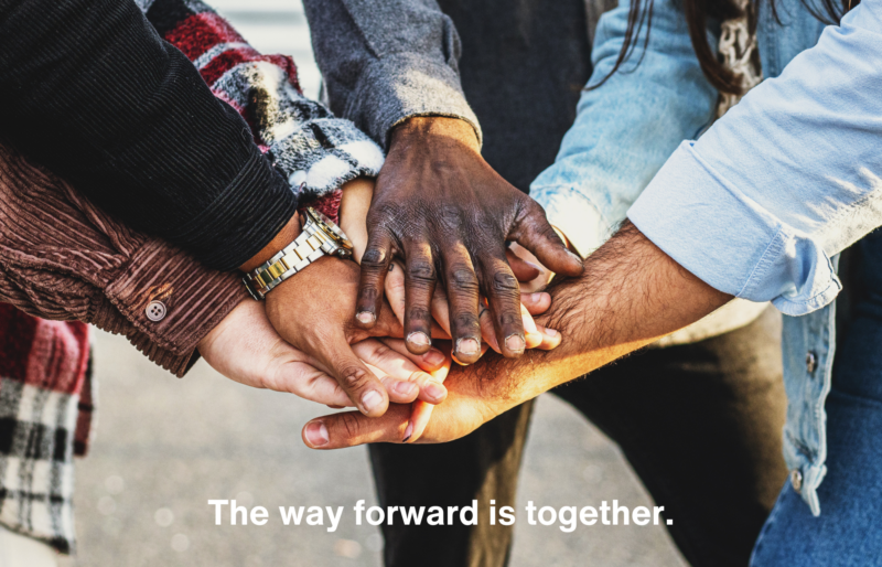 group of people clasping hands together