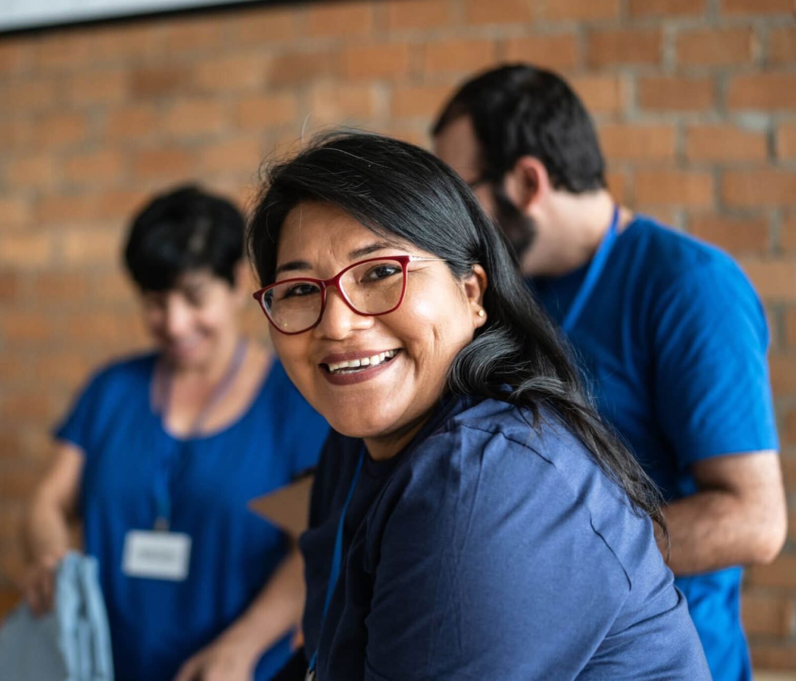 A charity worker smiling at the camera