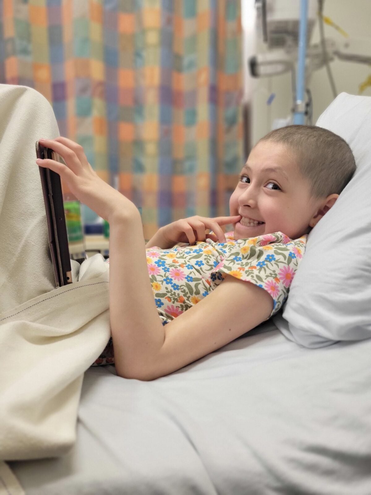 Emma smiles from her hospital bed