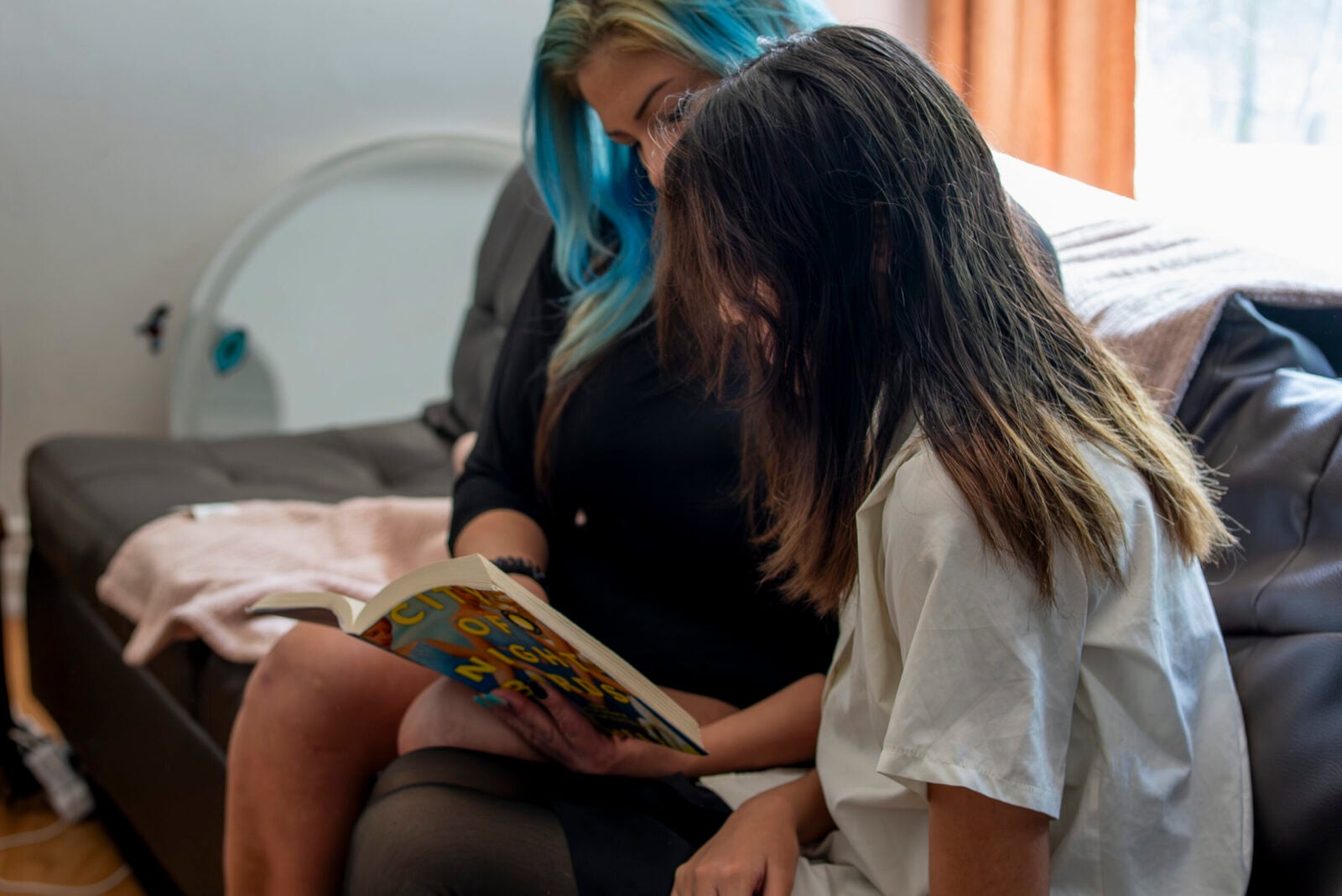 Mother and child reading together at WIN House, an Edmonton women’s shelter supporting families fleeing domestic and gender-based violence.