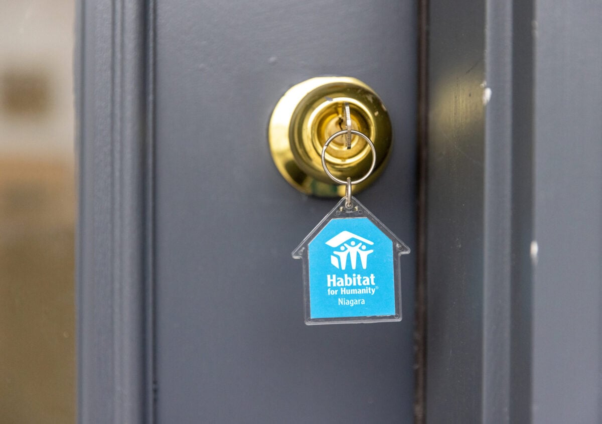 Habitat for Humanity Niagara keychain with key in the door